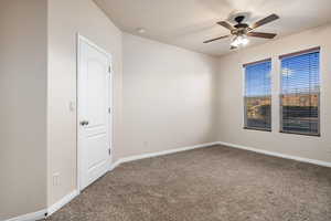 Empty room with ceiling fan and carpet