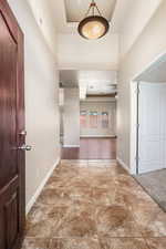 Hallway featuring a raised ceiling