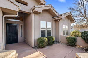 Doorway to property featuring a patio area