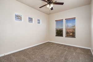 Carpeted empty room featuring ceiling fan