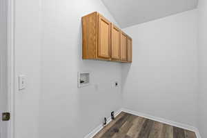 Laundry room with cabinets, hookup for a gas dryer, dark hardwood / wood-style flooring, washer hookup, and hookup for an electric dryer