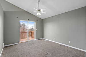 Spare room with ceiling fan, carpet flooring, and lofted ceiling