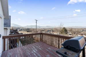 Wooden terrace featuring area for grilling and a mountain view