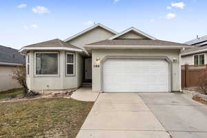 View of front facade with a garage and a front lawn