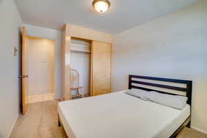 Bedroom featuring a closet and light colored carpet