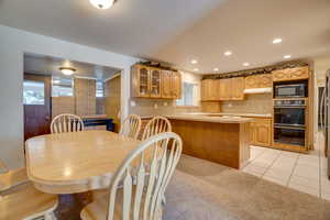 Dining area featuring light colored carpet