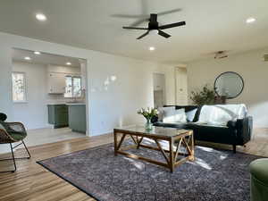 Living room with light hardwood / wood-style floors, and ceiling fan