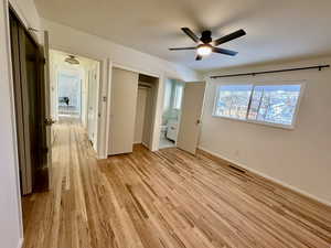 Master bedroom featuring ceiling fan, light hardwood / wood-style floors, and ensuite bathroom