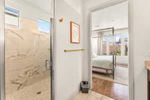 Bathroom featuring plenty of natural light, an enclosed shower, hardwood / wood-style floors, and vanity