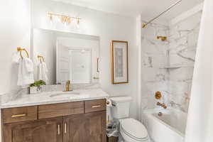 Full bathroom with vanity, toilet, and shower / bath combo with shower curtain