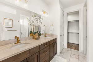 Bathroom featuring vanity and an enclosed shower