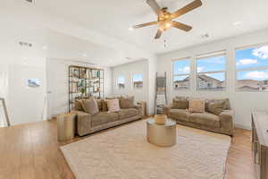 Living room featuring ceiling fan, a healthy amount of sunlight, and light wood-type flooring