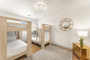 Bedroom with hardwood / wood-style flooring