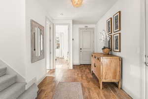 Corridor featuring wood-type flooring