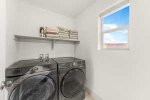 Clothes washing area featuring independent washer and dryer