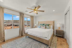 Bedroom featuring wood-type flooring, a textured ceiling, and ceiling fan