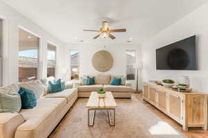 Living room featuring ceiling fan and light hardwood / wood-style floors