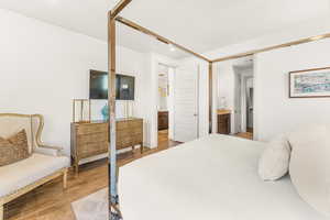 Bedroom with wood-type flooring and ensuite bath