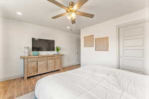 Bedroom with light hardwood / wood-style flooring and ceiling fan