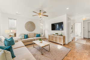 Living room featuring ceiling fan and light wood-type flooring