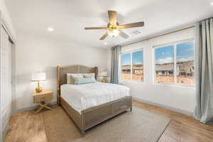 Bedroom featuring ceiling fan and light hardwood / wood-style flooring