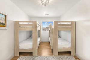 Unfurnished bedroom featuring hardwood / wood-style flooring and a textured ceiling