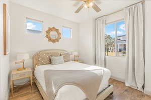 Bedroom with ceiling fan and wood-type flooring