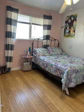 Bedroom featuring ceiling fan and wood-type flooring