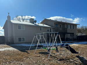 Back of house featuring a playground