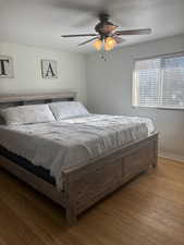 Bedroom featuring ceiling fan and light hardwood / wood-style floors