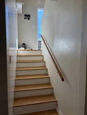 Staircase featuring hardwood / wood-style floors