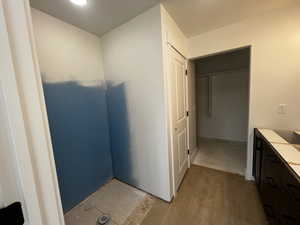 Bathroom featuring walk in shower and hardwood / wood-style flooring