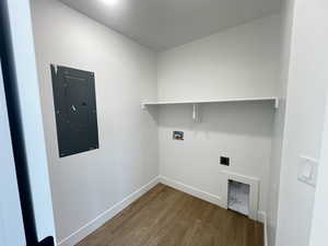 Laundry area featuring hardwood / wood-style floors, electric dryer hookup, hookup for a washing machine, and electric panel