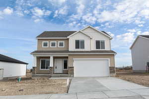 View of front of house featuring a porch, stone siding, concrete driveway, a garage, and a shingled roof