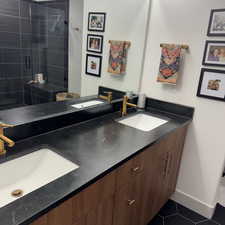 Bathroom featuring tile patterned floors, a sink, and double vanity