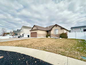 View of front facade with a front lawn and a garage