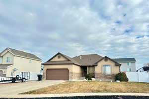 View of front of house with a front lawn and a garage