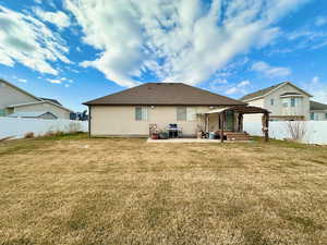 Rear of home.  Pergola stays.  Concrete pad.