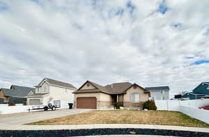 View of front facade with a garage and a front lawn