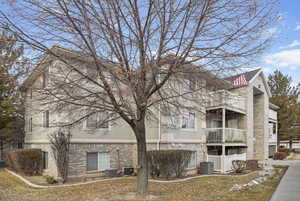 View of building exterior featuring cooling unit