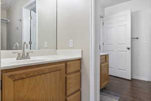 Bathroom with hardwood / wood-style floors and vanity