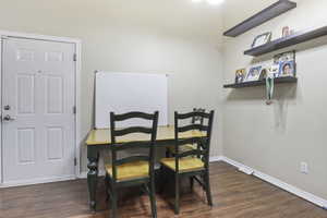 Dining space featuring dark wood-type flooring