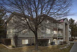 Exterior space with cooling unit and a balcony