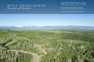 Aerial view of property and surrounding area with a mountainous background