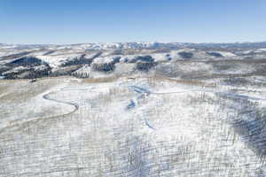 Snowy aerial view featuring a mountain view