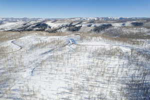 Snowy aerial view featuring a mountain view