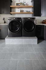 Washroom with cabinets, sink, and independent washer and dryer