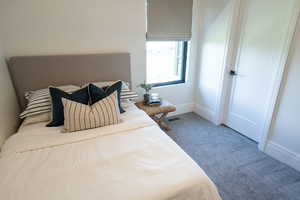 Carpeted bedroom featuring baseboards