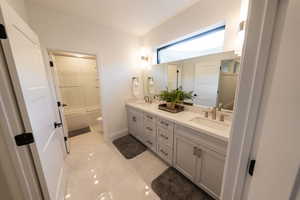 Bathroom with double vanity and shower / bath combination