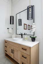 Bathroom with vanity and ornamental molding